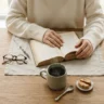 The Art of Stillness: Minimalist Flat Lay Photography of a Woman Reading with Coffee